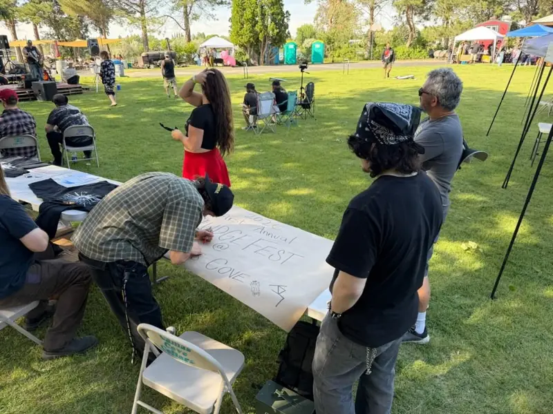 Signing the big paper on the lawn